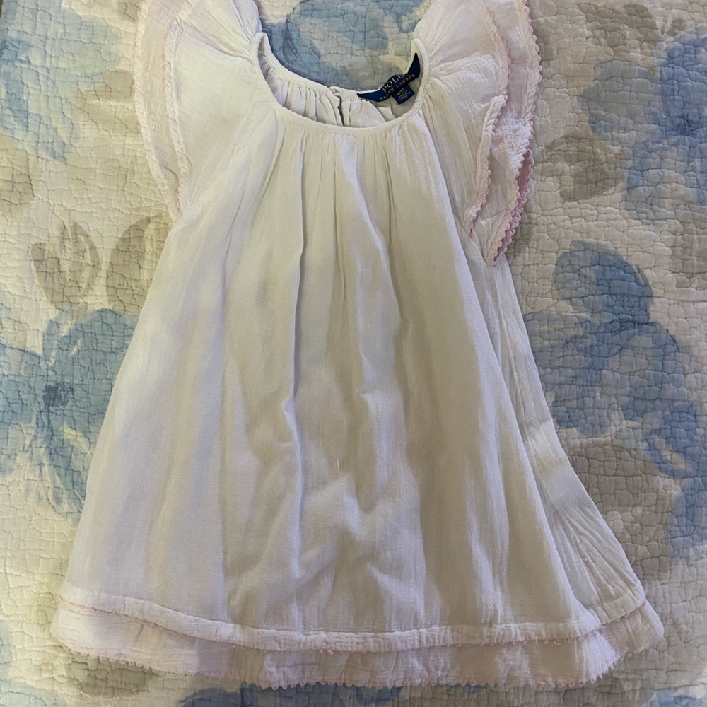 Beautiful white dress with pink trim and ruffled sleeves for a little girl